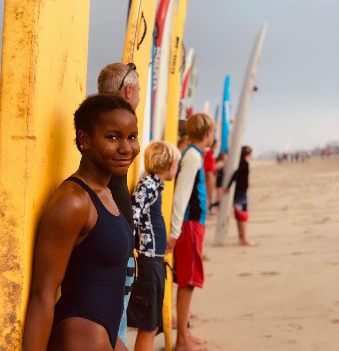 young women smiling for a photo who is part of the Junior Lifeguard.