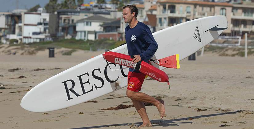 Lifeguard getting ready to enter the water.