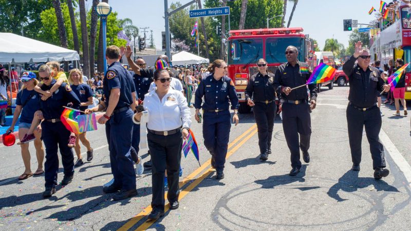 Los Angeles Pride Day firefighters walking in front of a fire engine.