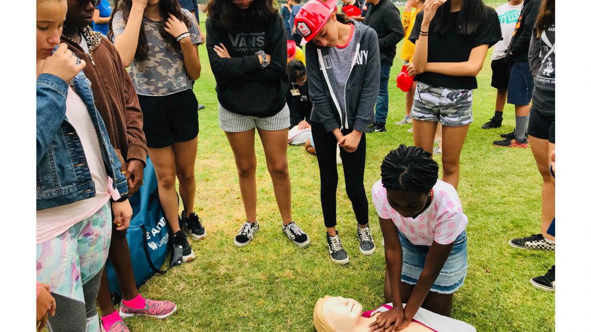Girl practicing CPR during San Dimas Open House