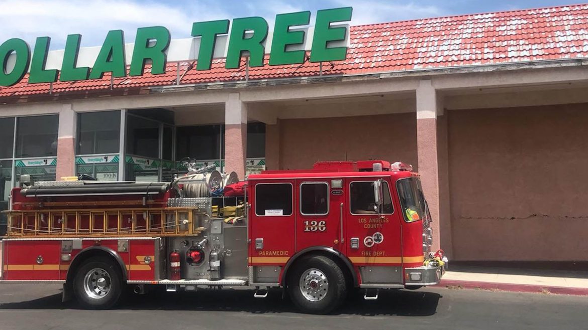 Fire truck in front of a dollar tree store.