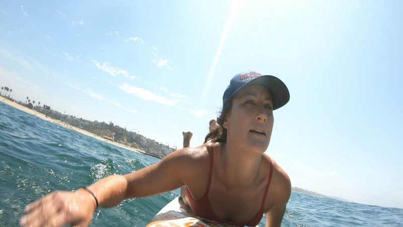 Lifeguard paddling in the ocean.