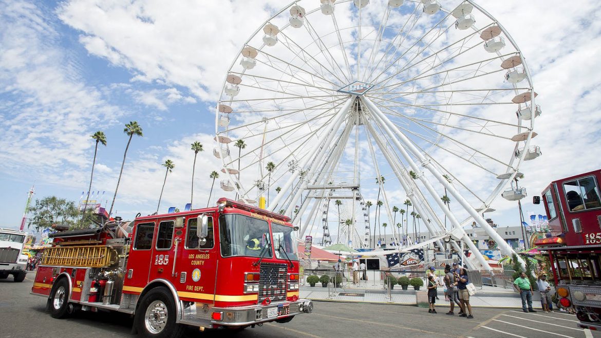 Fire truck with a ferris wheel in the background.