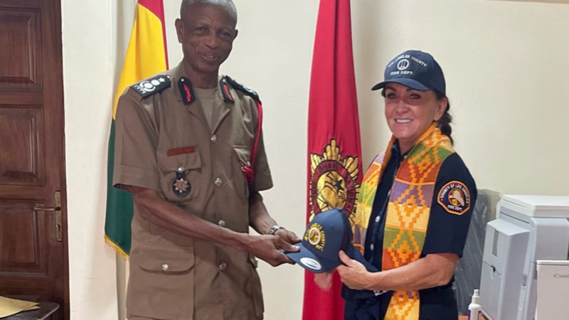 While on vacation with her family, Captain Sheila Kelliher from the Public Information Office met with the Chief of the Ghana National Fire Service.