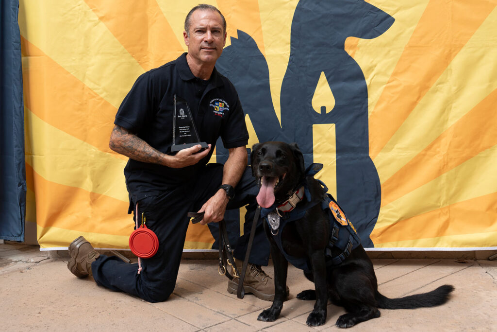 Roma and firefighter Derek Moree at the Helen Woodward Animal Center Pet Hero Award event